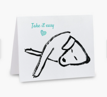 Load image into Gallery viewer, Card with a black and white illustration of a hand and a slice of pizza, with 'Take it easy' text on a white background.