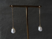 Load image into Gallery viewer, Pearl Gold-filled Chain Earrings are displayed on a brass stand.