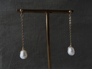 Pearl Gold-filled Chain Earrings are displayed on a brass stand.