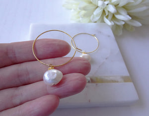Gold Hoop Pearl Earrings On A Hand