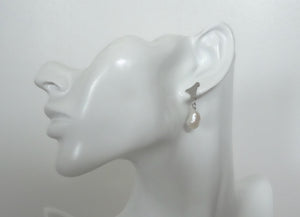 Pearl drop earrings, sustainable scrap metal  jewelry on a mannequin.