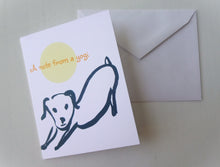 Load image into Gallery viewer, Greeting card with a dog illustration and 'a note from a yogi' text, accompanied by a white envelope on a light gray background.