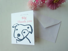 Load image into Gallery viewer, Card with dog illustration and 'Big Thank you' text, accompanied by a white envelope and pink flowers on a light background.