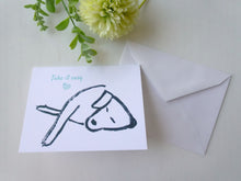 Load image into Gallery viewer, Card with drawing of a fish and text 'Take it easy' on a white surface with a flower.