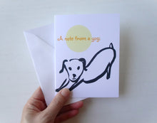 Load image into Gallery viewer, Hand holding a card with a dog illustration and 'A note from a yogi' text on a white background