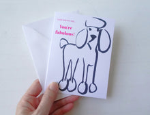 Load image into Gallery viewer, Hand holding a card with a dog illustration and text on a white background