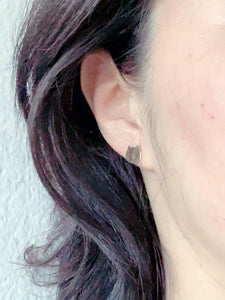 a woman wearing Gold Cat stud earrings