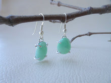 Load image into Gallery viewer, green jade earrings hanging from twig
